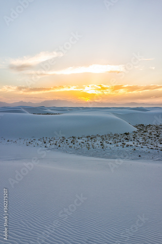 White sands dunes national monument park vertical view in New Mexico with horizon at sunset with silhouette of Organ Mountains