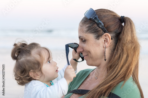 Mãe e filha trocando carinhos e olhares amorosos e cheios de ternura  photo