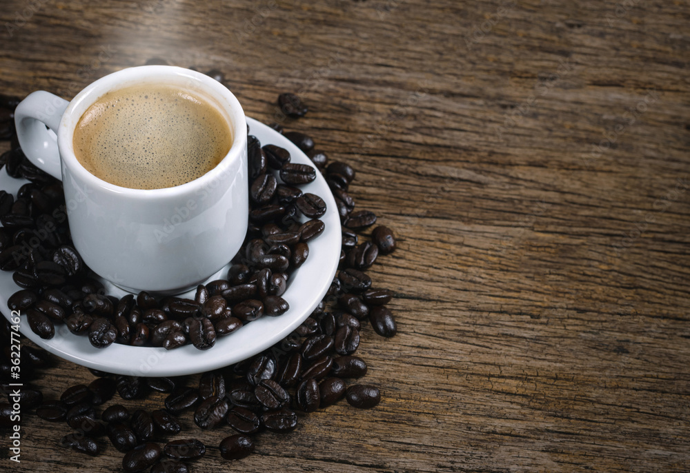 Coffee cup and coffee beans roasted in a sack on a wooden floor. Coffee cup and coffee beans roasted in a sack on a wooden floor.