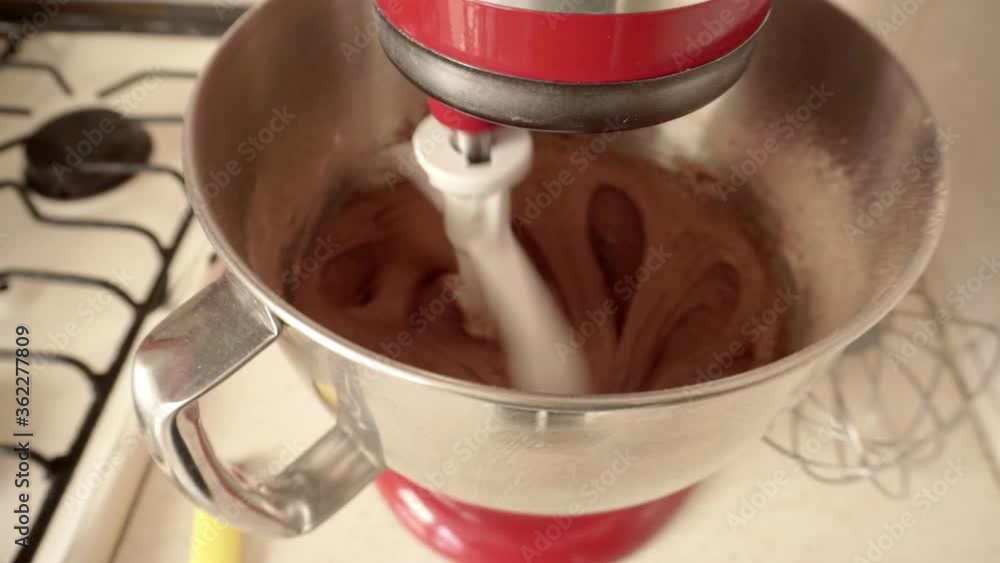 Red mixer mixing a chocolate cake mix. Red mixer mixing a chocolate cake mix.