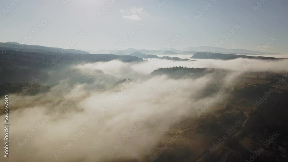 Aerial view of massive thick blanket of fog covering rural land