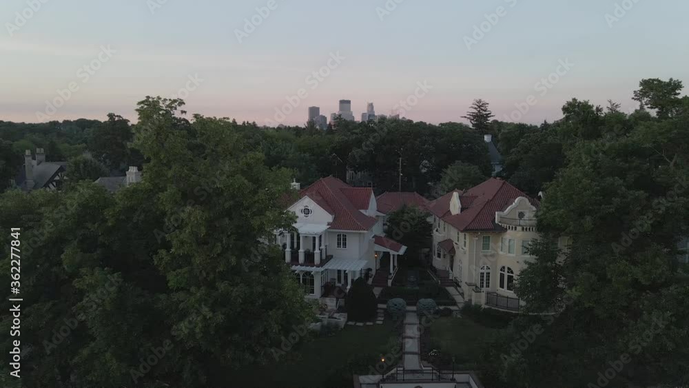 houses in the suburbs during summer time with downtown minneapolis view in the background houses in the suburbs during summer time with downtown minneapolis view in the background