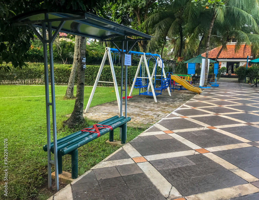 An empty childrens playground with social distancing red crosses An empty childrens playground with social distancing red crosses