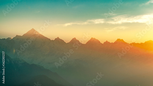 Mountain silhouette of Panchchuli peaks during morning sunrise in great Himalayan mountain chain range from Khalia Top at small hamlet Munsiyari  Kumaon region  Uttarakhand  India.
