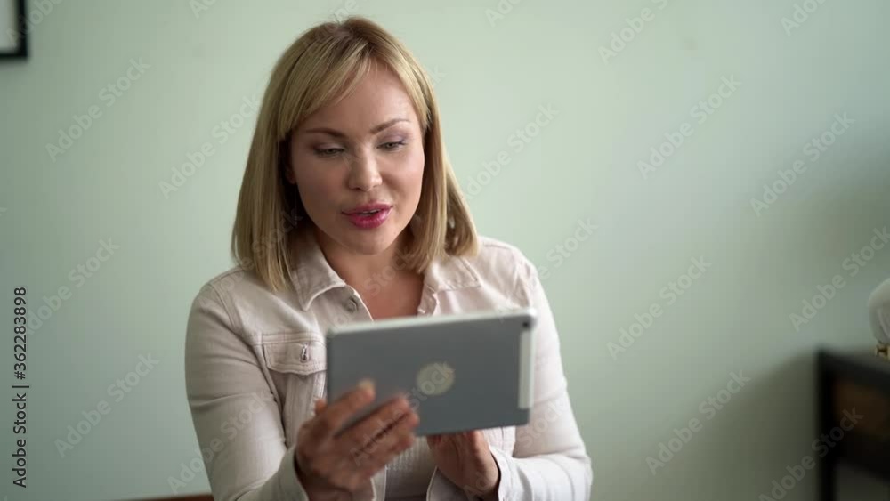 woman is talking by video call on tablet, introducing herself for job interview woman is talking by video call on tablet, introducing herself for job interview