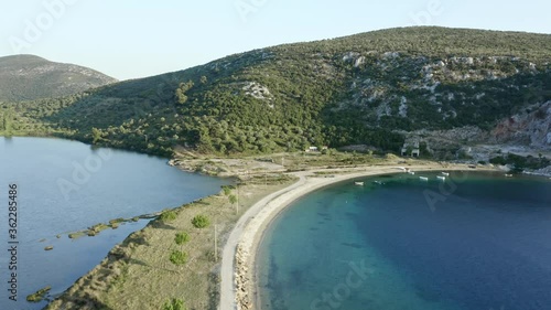 Aerial footage of sea bay and lake with narrow striped beach at Porto Koufos, Chalkidiki peninsula, Greece. photo