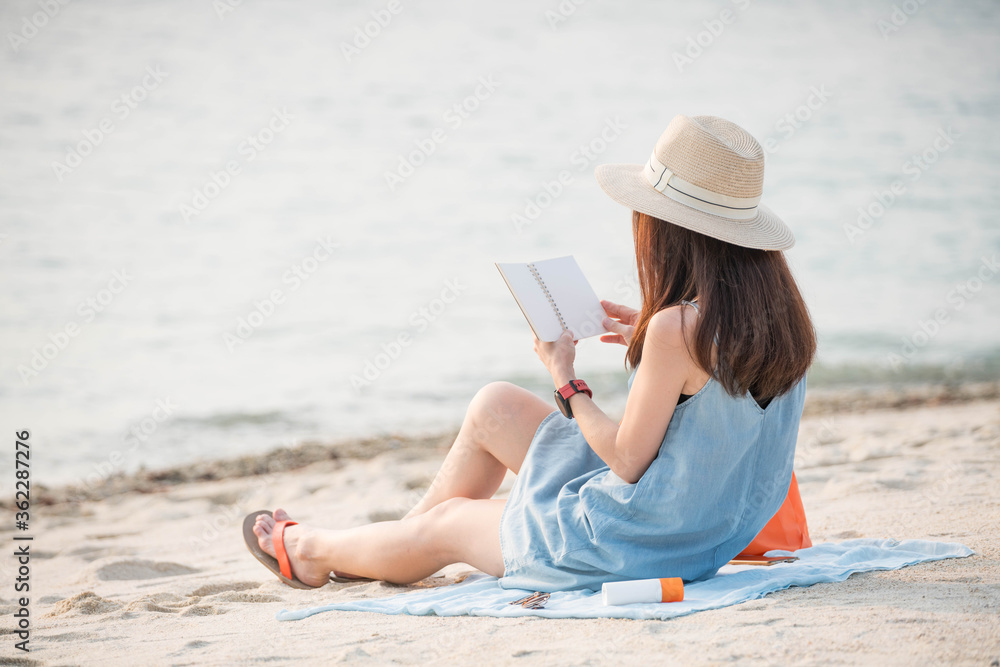 woman enjoy reading the book on the beach