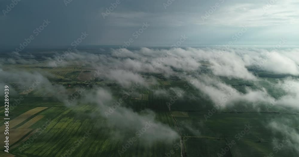 Green fields of aerial view can be seen through the clouds. Agroindustry Ukraine Rivne Green fields of aerial view can be seen through the clouds. Agroindustry Ukraine Rivne