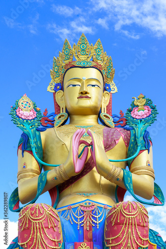 Closeup giant Maitreya Buddha statue with blue sky with clouds in Nubra Valley, Ladakh, Northern India.