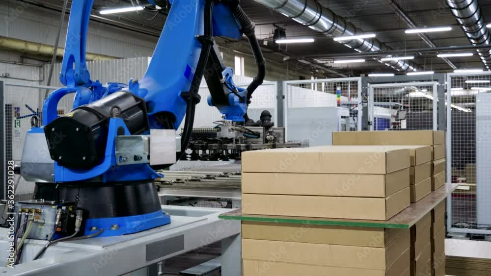 Furniture factory. A modern automated machine packaging furniture parts in cardboard boxes. 4K Furniture factory. A modern automated machine packaging furniture parts in cardboard boxes. 4K