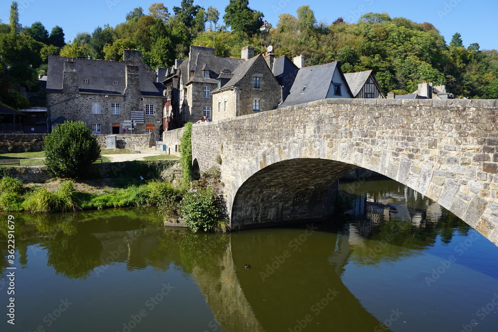 old stone bridge over the river in france with mirror reflection in the river