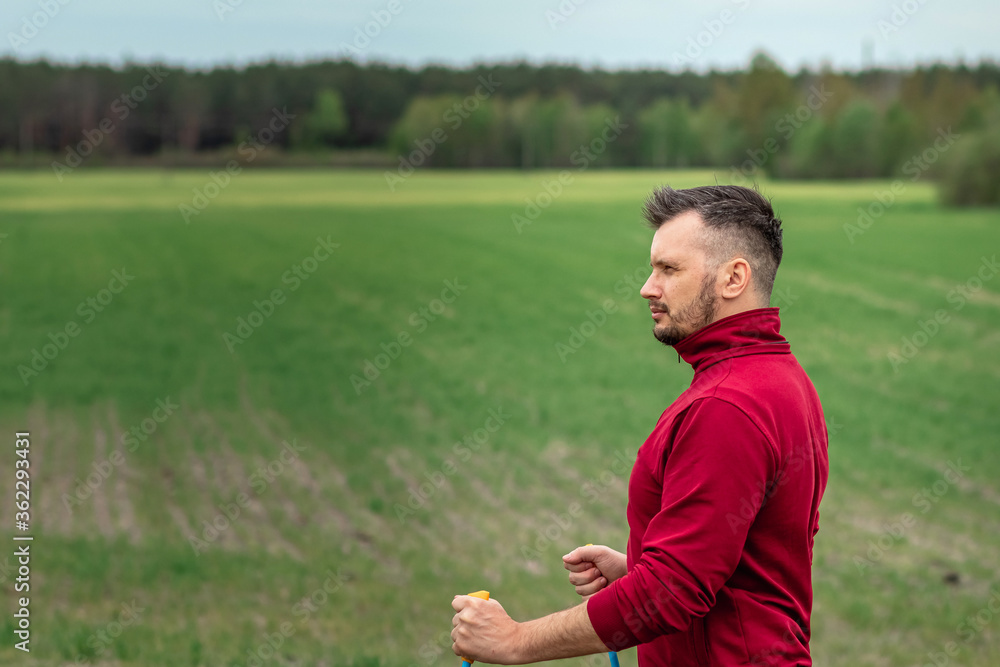Sports, outdoor activities, Nordic walking, a man with sticks close-up. The concept of a healthy lifestyle, cardio training. Copyspace. Sports, outdoor activities, Nordic walking, a man with sticks close-up. The concept of a healthy lifestyle, cardio training. Copyspace.