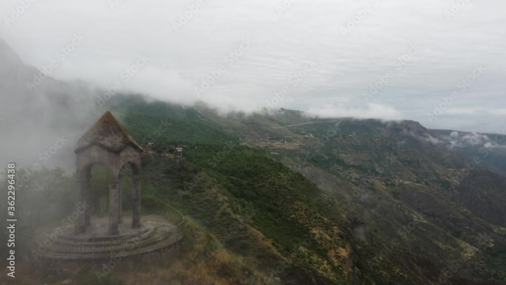 Aerial Drone view of Small chapel in the top of the mountain, surrounded by fog and clouds. Highland old building in Armenia, Caucasus Aerial Drone view of Small chapel in the top of the mountain, surrounded by fog and clouds. Highland old building in Armenia, Caucasus