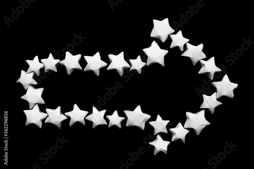 Fototapeta Naklejka Na Ścianę i Meble -  Arrow design elements with empty space for text inside pointing to the right made of white paper stars on a black background