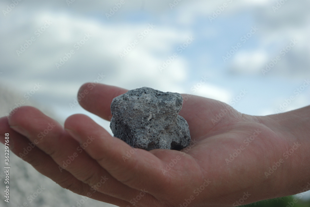 The gray stone lies in the hand The gray stone lies in the hand