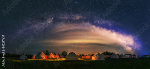 Under the bright Milky Way, Mongolia yurts on the grassland are scattered. photo