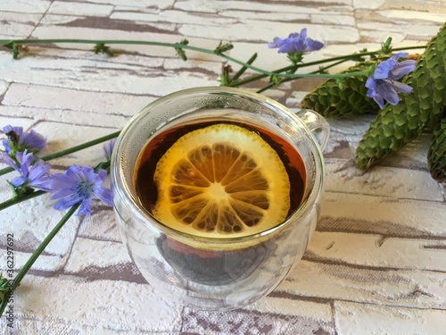 black tea with lemon in a transparent cup