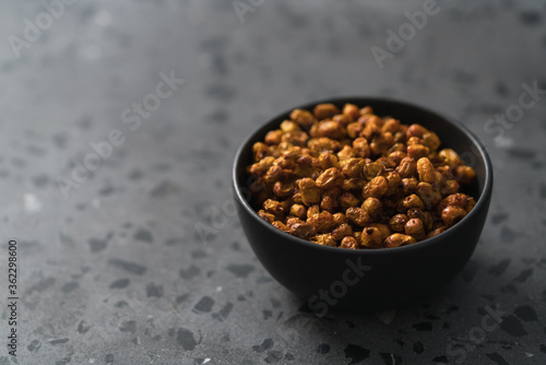 dried seaberry buckthorn in black bowl on terrazzo countertop with copy space