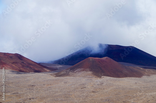 View of Volcano craters from Mauna Kea Mountain summit at sunset on Big Island in Hawaii with breathtaking landscape scenic view from top photo