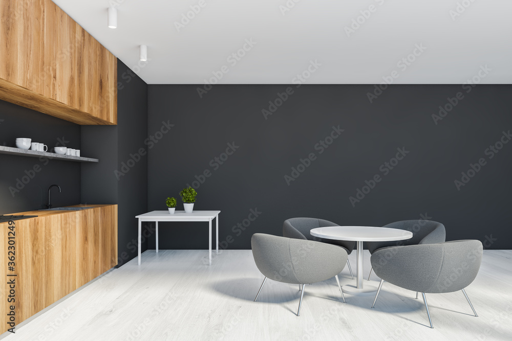 Fototapeta premium Black and wooden kitchen with round table