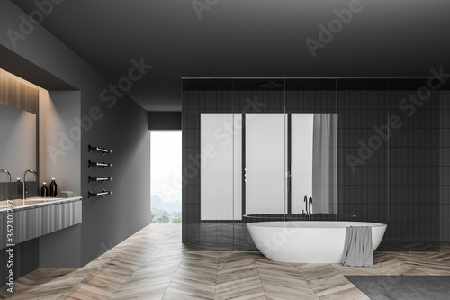 Grey bathroom with tub  sink and shower