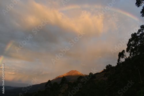 rainbow over the mountains during sunrise