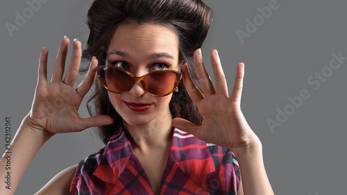 Young amazing woman in sunglasses look to right.