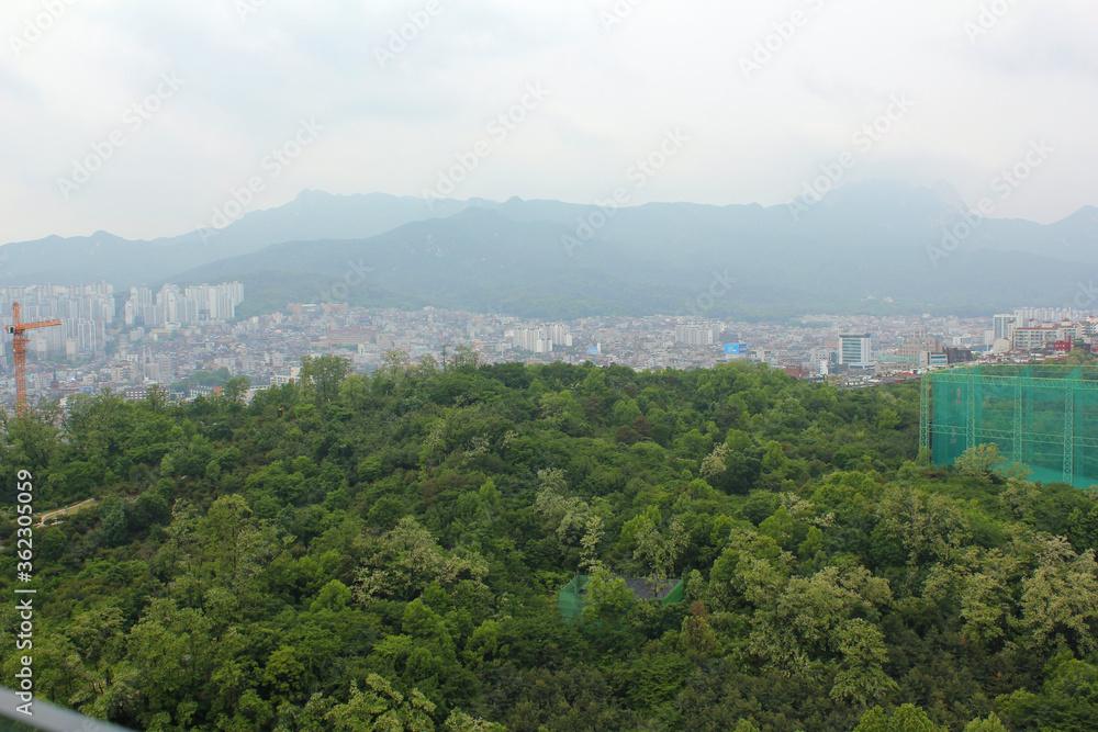 SEOUL, SOUTH KOREA ;  Aerial view of Seoul, houses and forest view .