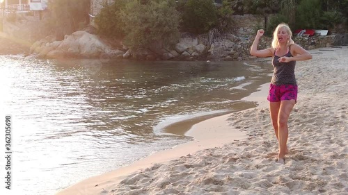 Angry girl in the Scaglieri beach of Elba island in Italy screaming in SLOW MOTION. Tyrrhenian sea holiday travel. Funny squabble on the beach. photo