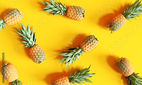 Pattern summer pineapples on yellow background