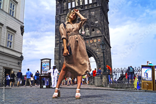 Happy young beautiful girl laughing on the background of Charles Bridge in Prague