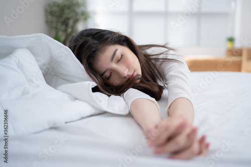 Asian woman sleeping in bed