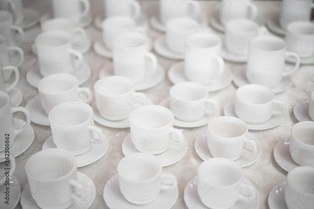 photo of many white mugs for coffee and tea