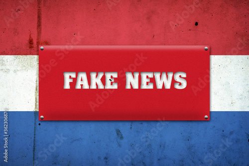 Fake news. The inscription on a red plate on the background of the flag of the Netherlands. Information