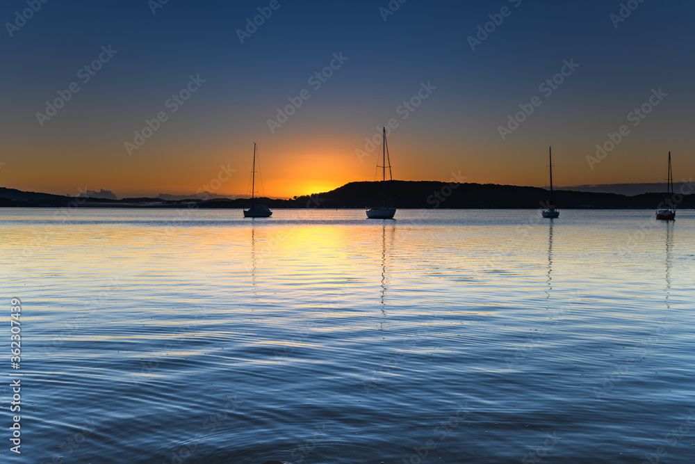 Sunrise, boats and a clear sky over the Bay