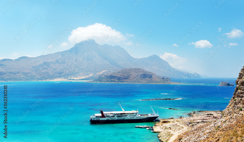 Greece Crete. Ship in lagoon of Gramvousa island. Beautiful sea coast. Panoramic view for sea and mountains. Postcard, offer or advertisement for travelers