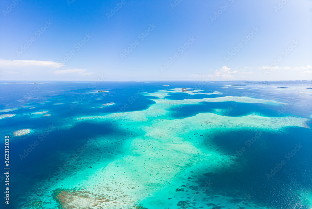Aerial: exotic tropical coral reef secluded destination away from it all, caribbean sea turquoise water white sand beach. Indonesia Sumatra Banyak islands
