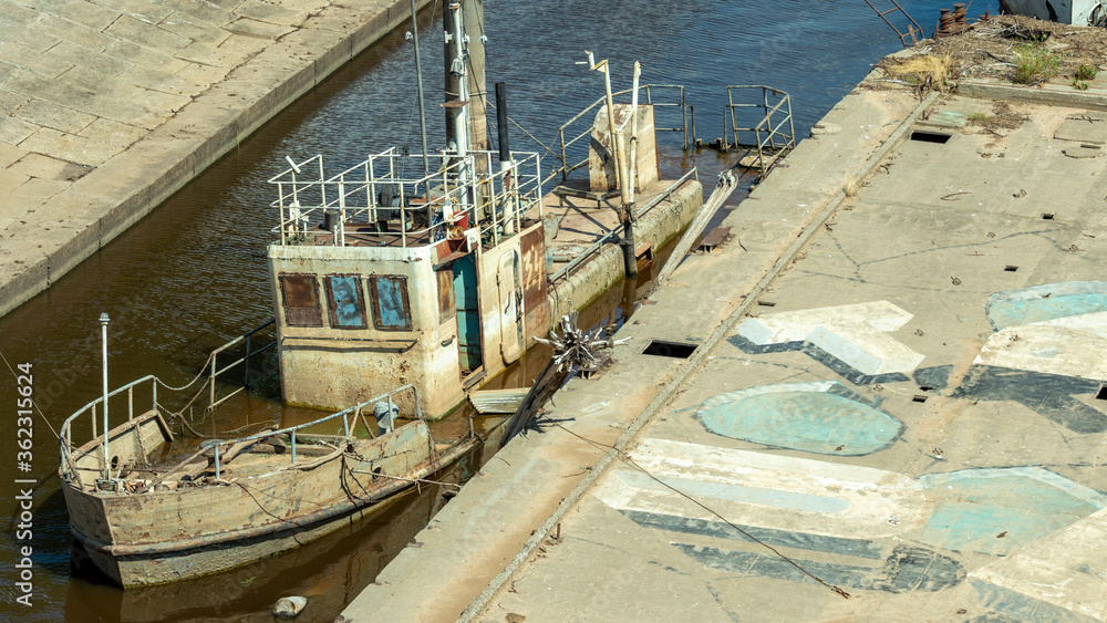 an old and rusty wreck in the dock an old and rusty wreck in the dock