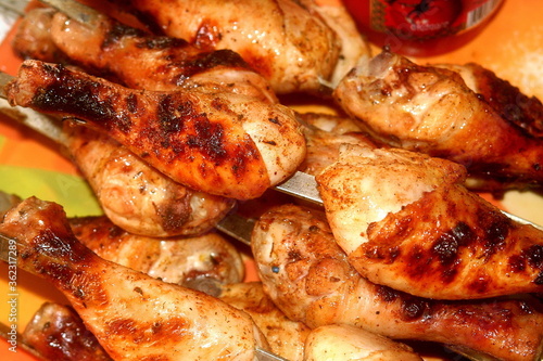 Charcoal-fried chicken shins strung on skewers closeup