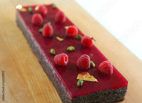 Raspberry cake with pistachio and gold photo