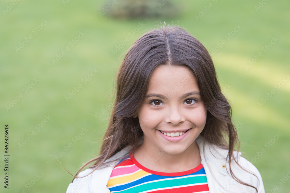 I am happy child. Cheerful schoolgirl. Girl cute kid green grass. Emotional happy kid relaxing outdoors. Summer vacation. Vacation ideas. Happy smiling girl enjoy relax on lawn. Portrait close up I am happy child. Cheerful schoolgirl. Girl cute kid green grass. Emotional happy kid relaxing outdoors. Summer vacation. Vacation ideas. Happy smiling girl enjoy relax on lawn. Portrait close up