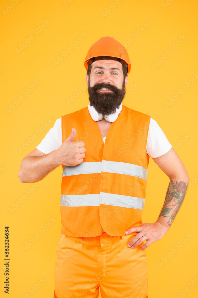 Creative solutions. Man protective hard hat and uniform. Strong handsome builder. Indoors works. Dangerous works. Worker brutal bearded builder confident looking camera. Protective equipment concept Creative solutions. Man protective hard hat and uniform. Strong handsome builder. Indoors works. Dangerous works. Worker brutal bearded builder confident looking camera. Protective equipment concept