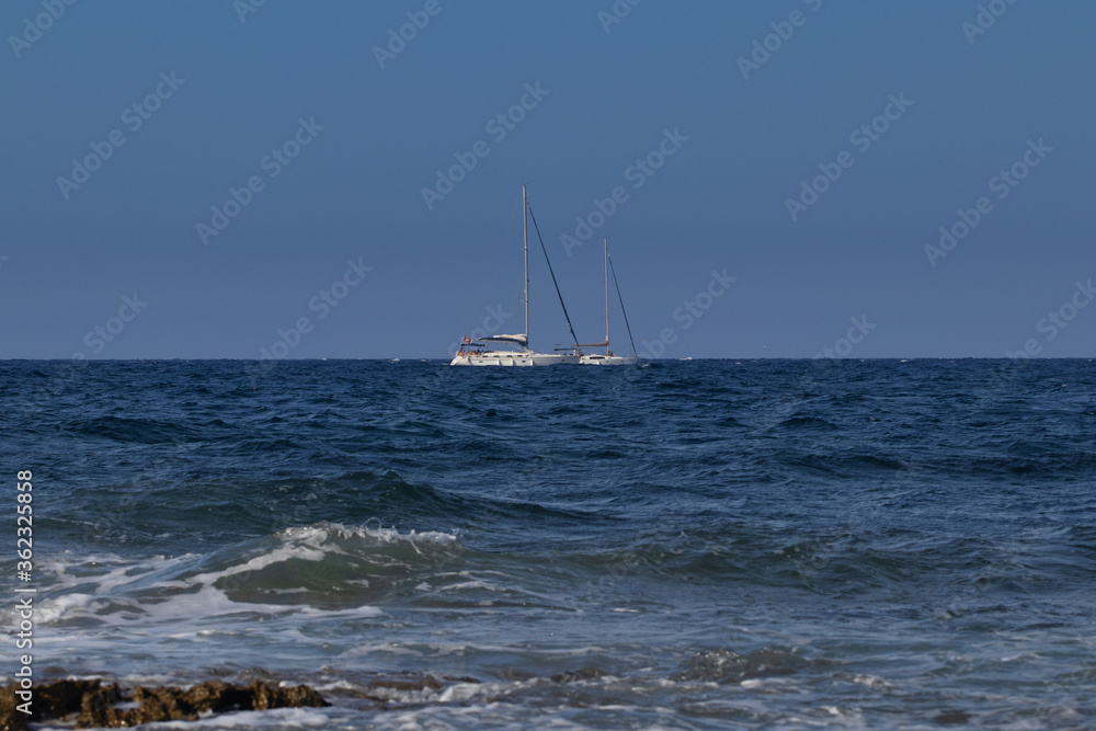 two sailing boats on the sea horizon. sailing boat in the summer navigate on the water