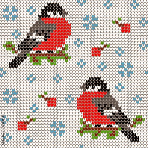 Jacquard knitted seamless pattern with cute bullfinchies, rowanberries and snowflakes. Winter background with nature and birds. Scandinavian style. Vector illustration.