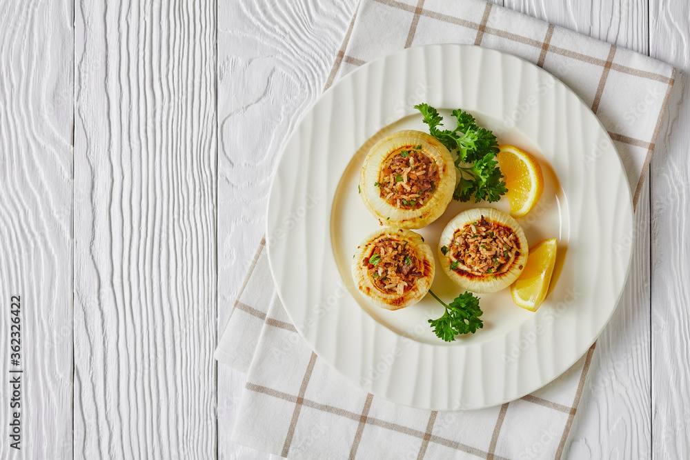 a portion of baked onions stuffed with minced lamb