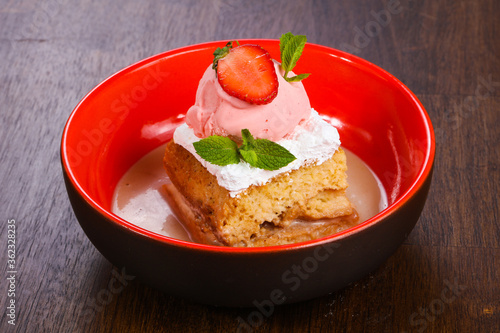 Cake with ice cream served stravberry