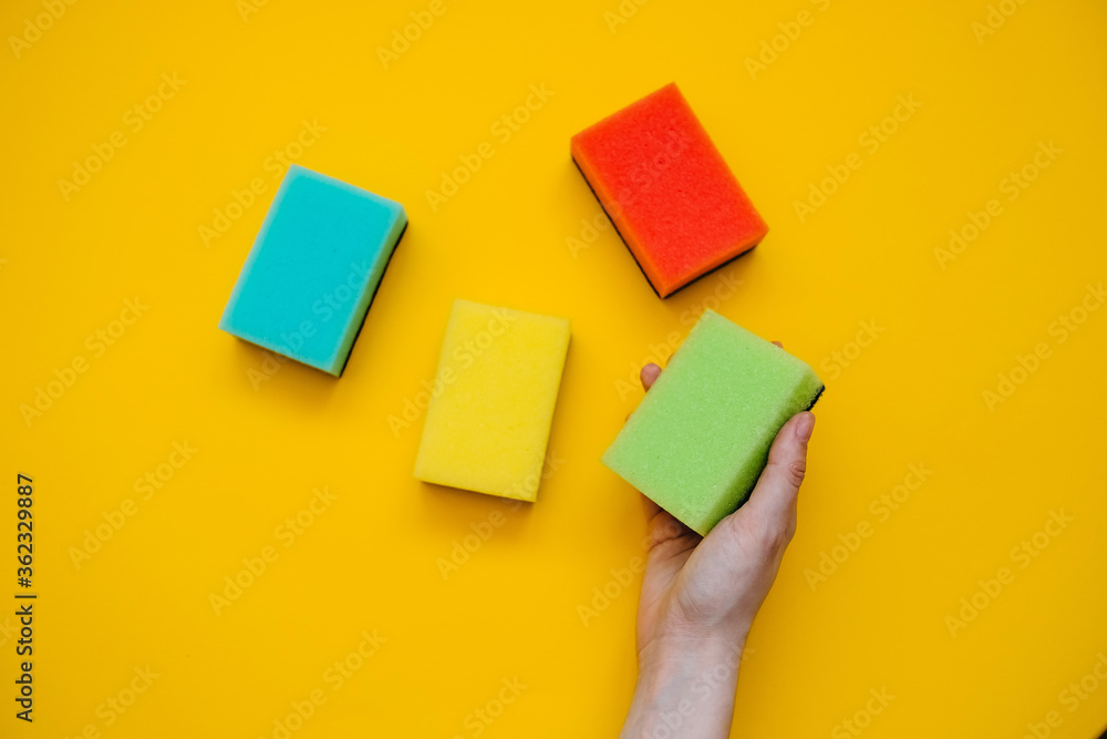 Colorful dish sponges on bright yellow background. Concept of cleaning. Colorful dish sponges on bright yellow background. Concept of cleaning.