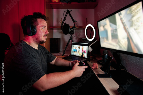 a gamer playing and streaming live with microphones and cameras