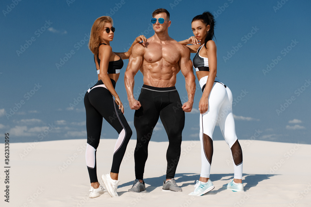 Sporty fitness models in sportswear. Athletic man and women in leggings  outdoor Stock Photo