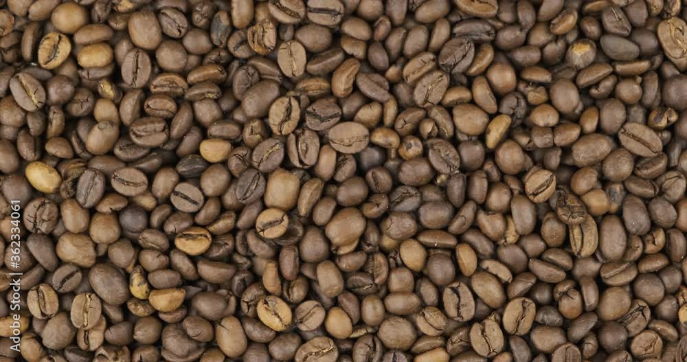 Coffee beans background, texture. Rotation and zoom out of grain background.